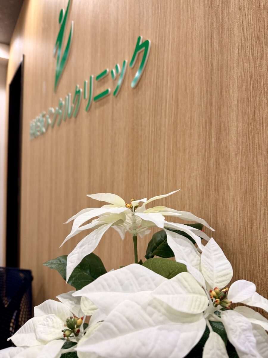 受付の白い花とロゴ